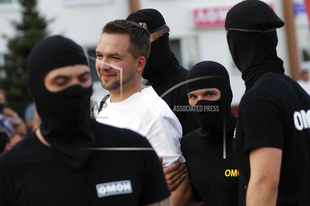 Sergei Grits Police detain a protester trying to attend a rally in support of opposition candidate Sviatlana Tsikhanouskaya ahead of Sunday's election in Slutsk, Belarus, Tuesday, Aug. 4, 2020. Belarusian police on Tuesday, abruptly banned Tsikhanouskaya's previously approved rally in the city of Slutsk, about 100 kilometers (about 60 miles) south of Minsk, under the pretext of road repairs. Officers dispersed several hundred people who had gathered for the rally and detained at least 20 of them, according to Belarusian human rights organization Viasna. (AP Photo/Sergei Grits)