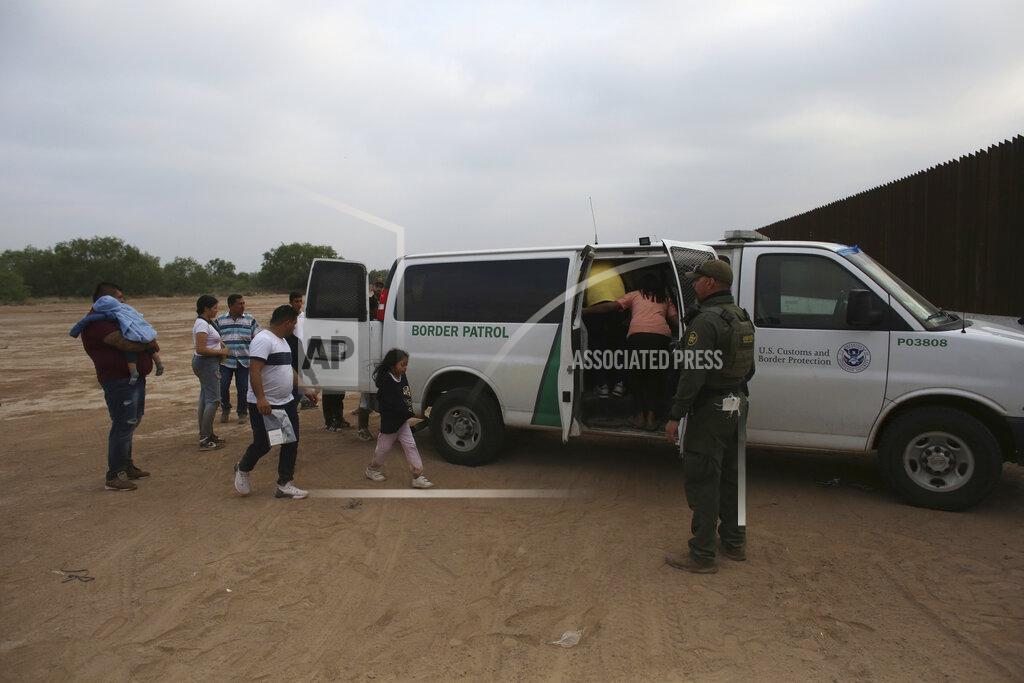 Dario Lopez-Mills Migrants who had crossed the Rio Grande river into the U.S. are taken away by U.S. Border Patrol agents in Eagle Pass, Texas, Friday, May 20, 2022. The Eagle Pass area has become increasingly a popular crossing corridor for migrants, especially those from outside Mexico and Central America, under Title 42 authority, which expels migrants without a chance to seek asylum on grounds of preventing the spread of COVID-19. A judge was expected to rule on a bid by Louisiana and 23 other states to keep Title 42 in effect before the Biden administration was to end it Monday. (AP Photo/Dario Lopez-Mills)