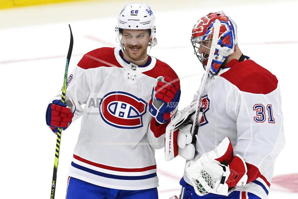 Frank Gunn Montreal Canadiens' Jon Merrill (28) and Carey Price (31) celebrate the team's overtime win against the Toronto Maple Leafs in Game 5 of an NHL hockey Stanley Cup first-round playoff series in Toronto on Thursday, May 27, 2021. (Frank Gunn/The Canadian Press via AP)