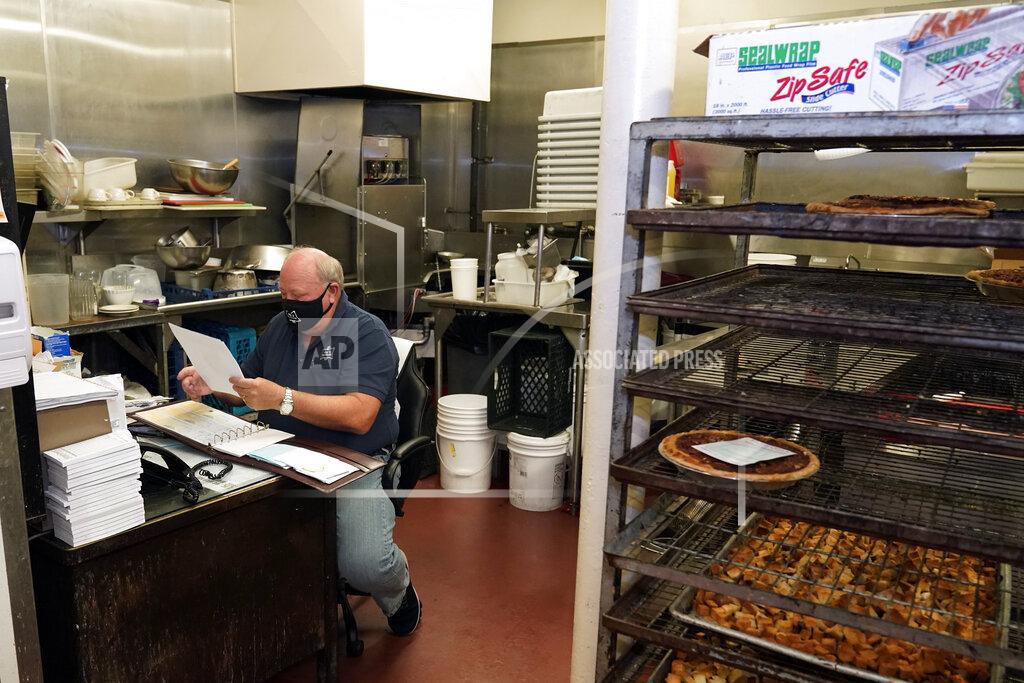 Marcio Jose Sanchez *** Hold For Story *** Pie 'N Burger owner Michael Osborn sits in his office in his restaurant Tuesday, Dec. 1, 2020, in Pasadena, Calif. Pasadena has become an island in the center of the nation's most populous county, where a surge of COVID-19 cases last week led to a three-week end to outdoor dining and California's first stay-home order since the pandemic began to spread across the state in March. (AP Photo/Marcio Jose Sanchez)
