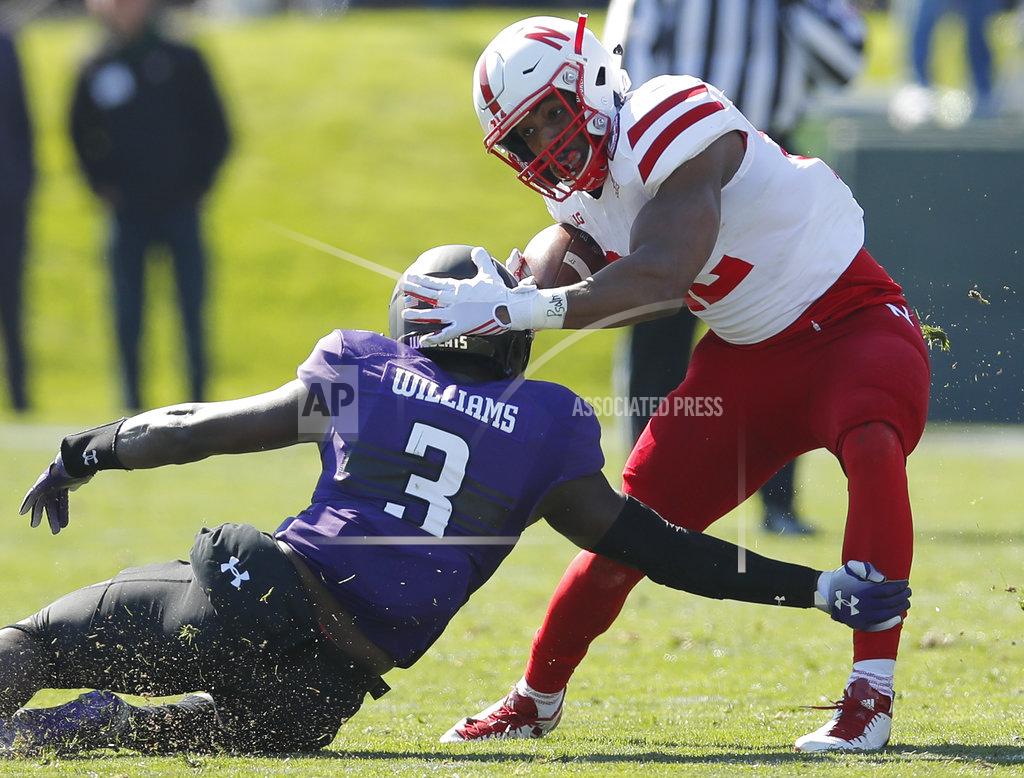 Jim Young Nebraska's Devine Ozigbo, right, tries to break a tackle by Northwestern's Trae Williams during the first half of an NCAA college football game Saturday, Oct. 13, 2018, in Evanston, Ill.. (AP Photo/Jim Young)