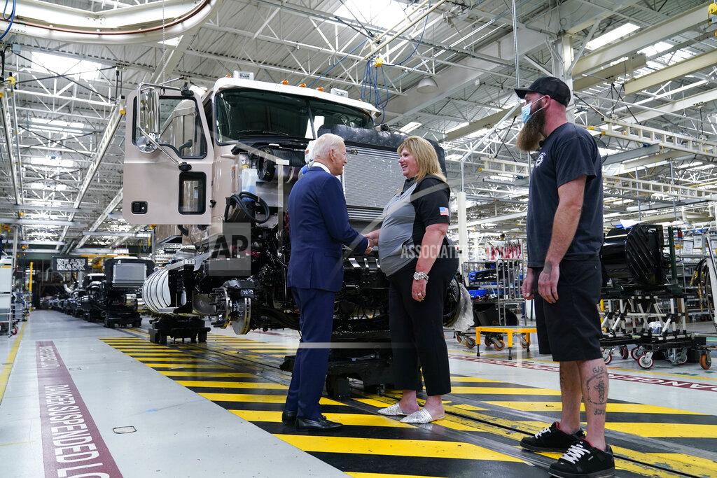 Susan Walsh President Joe Biden shakes hands with Tammy Flower, team manager, as he tours the Lehigh Valley operations facility for Mack Trucks in Macungie, Pa., Wednesday, July 28, 2021. (AP Photo/Susan Walsh)