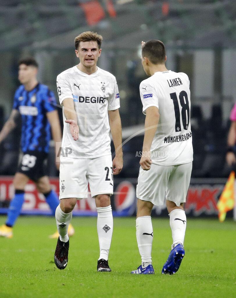 Luca Bruno Moenchengladbach's Jonas Hofmann, left, celebrates with his teammate Stefan Lainer after scoring his side's second goal during the Champions League group B soccer match between Inter Milan and Borussia Moenchangladbach at the San Siro stadium in Milan, Italy, Wednesday, Oct. 21, 2020. (AP Photo/Luca Bruno)