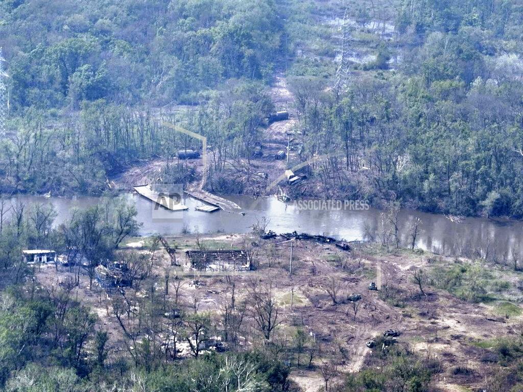 Uncredited In this handout photo provided by the Ukraine Armed Forces on Thursday, May 12, 2022, a ruined pontoon crossing with dozens of destroyed or damaged Russian armored vehicles on both banks of Siverskyi Donets River after their pontoon bridges were blown up in eastern Ukraine. (Ukrainian Presidential Press Office via AP)