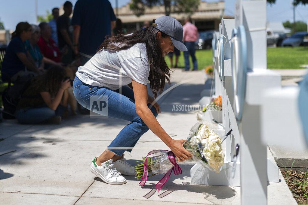 Jae C. Hong Meghan Markle, Duchess of Sussex, leaves flowers at a memorial site, Thursday, May 26, 2022, for the victims killed in this week's elementary school shooting in Uvalde, Texas. (AP Photo/Jae C. Hong)