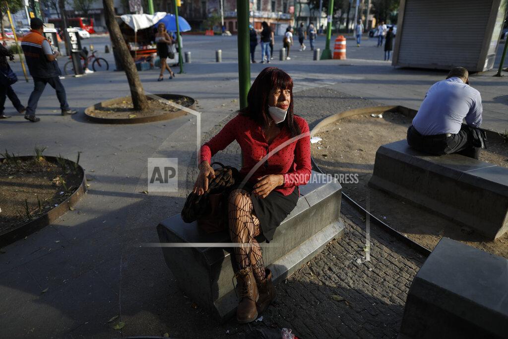 Rebecca Blackwell Sex worker Laura, 62, waits for clients outside the Revolution subway station, in Mexico City, Saturday, March 13, 2021. In addition to increased competition and fewer clients, sex workers in the area have to contend with many clients who only want to pay with crack cocaine, or who insist the women smoke with them, leaving recovering drug users like Laura in the difficult position of having to turn down work in order to protect her year of sobriety. (AP Photo/Rebecca Blackwell)