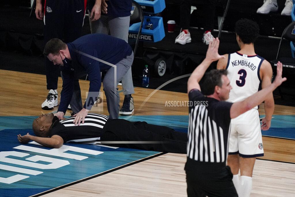 Michael Conroy Referee Bert Smith collapses on the court during the first half of an Elite 8 game between Gonzaga and Southern California in the NCAA men's college basketball tournament at Lucas Oil Stadium, Tuesday, March 30, 2021, in Indianapolis. (AP Photo/Michael Conroy)