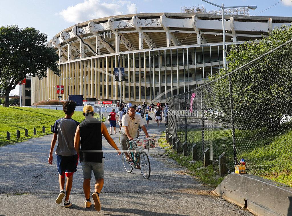 Pablo Martinez Monsivais FILE - In this Aug. 5, 2017, file photo people make their way to RFK Stadium in Washington before an MLS soccer match between D.C. United and Toronto FC. The stadium, the former home of the NFL’s Washington Redskins, Major League Baseball’s Washington Nationals and Senators, and Major League Soccer’s D.C. United, will be demolished by 2021, local officials in Washington said. (AP Photo/Pablo Martinez Monsivais, File)
