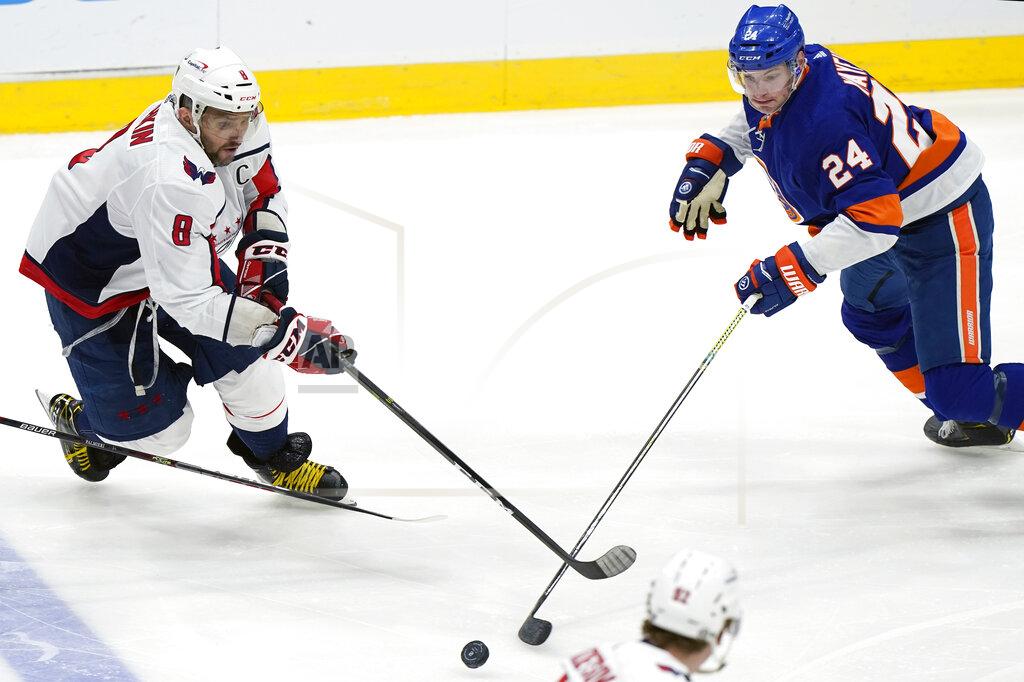 Kathy Willens New York Islanders defenseman Scott Mayfield (24) and Washington Capitals left wing Alex Ovechkin (8) go after the puck during the second period of an NHL hockey game Thursday, April 22, 2021, in Uniondale, N.Y. (AP Photo/Kathy Willens)