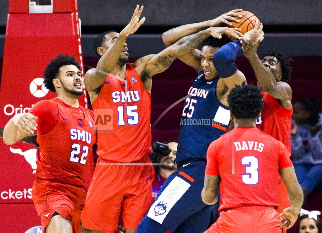 Ashley Landis SMU players defend against Connecticut center Josh Carlton (25) during the first half of an NCAA college basketball game Wednesday, Feb. 12, 2020, in Dallas. (Ashley Landis/The Dallas Morning News via AP)