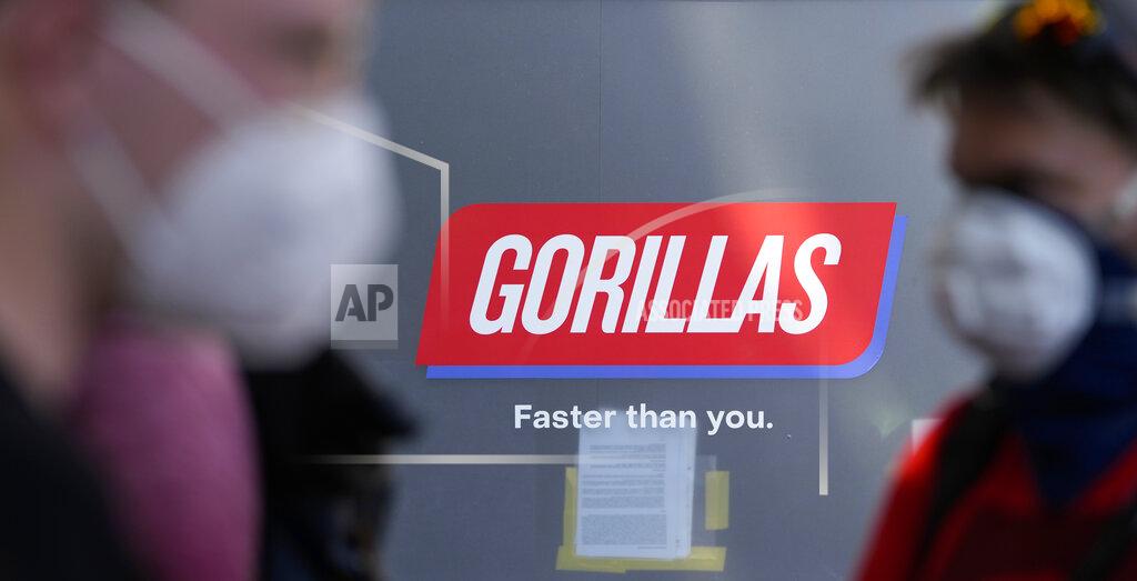 Workers block the entrance of a depot for German startup Gorillas, a grocery delivery company, during a protest against the firing of a colleague in Berlin, Germany, Thursday, June 10, 2021. The delivery service Gorillas now operates in dozens of cities across Germany, France, Italy, the Netherlands and Britain, and has already set its sights on New York. (AP Photo/Markus Schreiber)