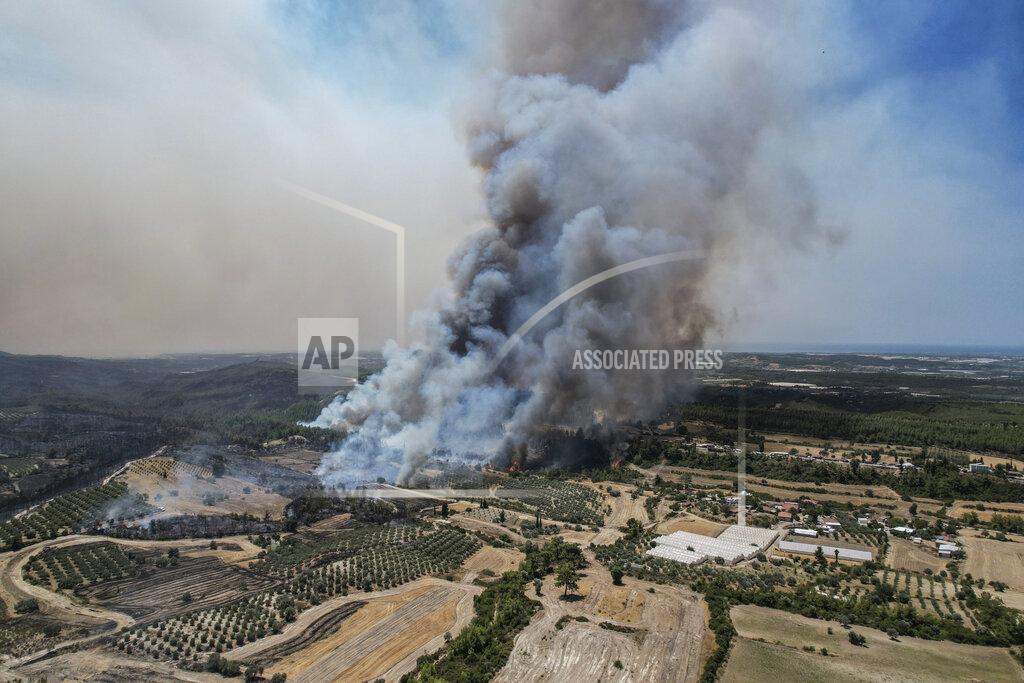 Uncredited An aerial photo shows wildfires in Kacarlar village near the Mediterranean coastal town of Manavgat, Antalya, Turkey, Saturday, July 31, 2021. The death toll from wildfires raging in Turkey's Mediterranean towns rose to six Saturday after two forest workers were killed, the country's health minister said. Fires across Turkey since Wednesday burned down forests, encroaching on villages and tourist destinations and forcing people to evacuate. (AP Photo)