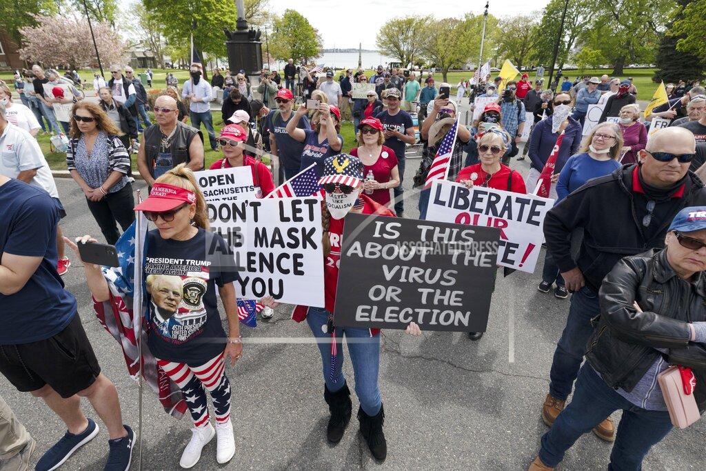Michael Dwyer People demonstrate against state restrictions imposed over concern about COVID-19 near the residence of Gov. Charlie Baker, Saturday, May 16, 2020, in Swampscott, Mass. (AP Photo/Michael Dwyer)