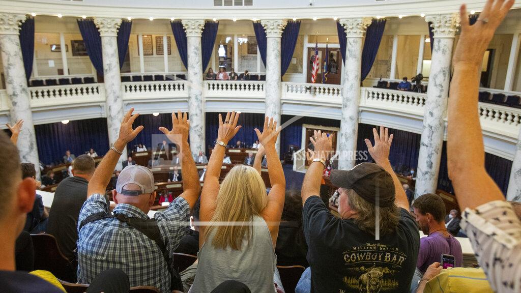 Katherine Jones FILE - In this Aug. 25, 2020, file photo, spectators in the Capitol gallery in Boise, Idaho, silently indicate their approval for speakers who supported a resolution as the House debated a concurrent resolution that would end the coronavirus emergency declaration that Gov. Brad Little signed in March. When President Trump-supporting insurrectionists stormed the U.S. Capitol in an attempt to overturn the presidential election on Wednesday, Jan. 6 2021 the nation was shocked, but not unwarned. A series of dress rehearsals of sorts have played out in statehouses in Michigan, Oregon, Idaho and elsewhere in recent months, with armed protesters forcing their way into buildings. (Katherine Jones/Idaho Statesman via AP)