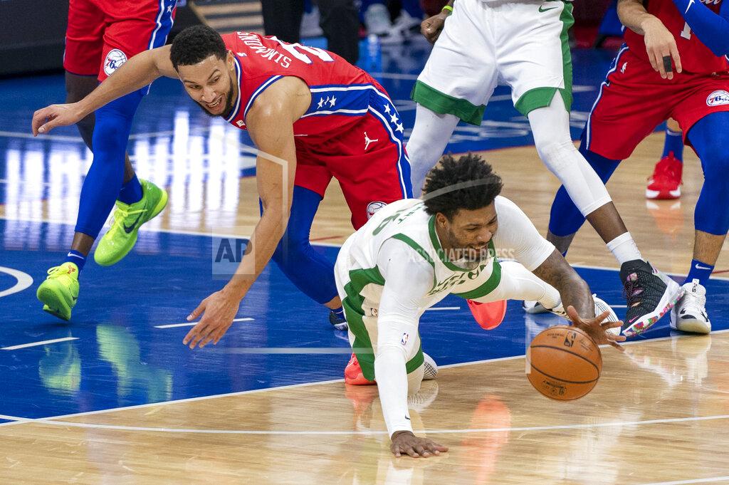 Chris Szagola Boston Celtics' Marcus Smart, right, dives for the ball with Philadelphia 76ers' Ben Simmons, left, during the first half of an NBA basketball game, Friday, Jan. 22, 2021, in Philadelphia. (AP Photo/Chris Szagola)
