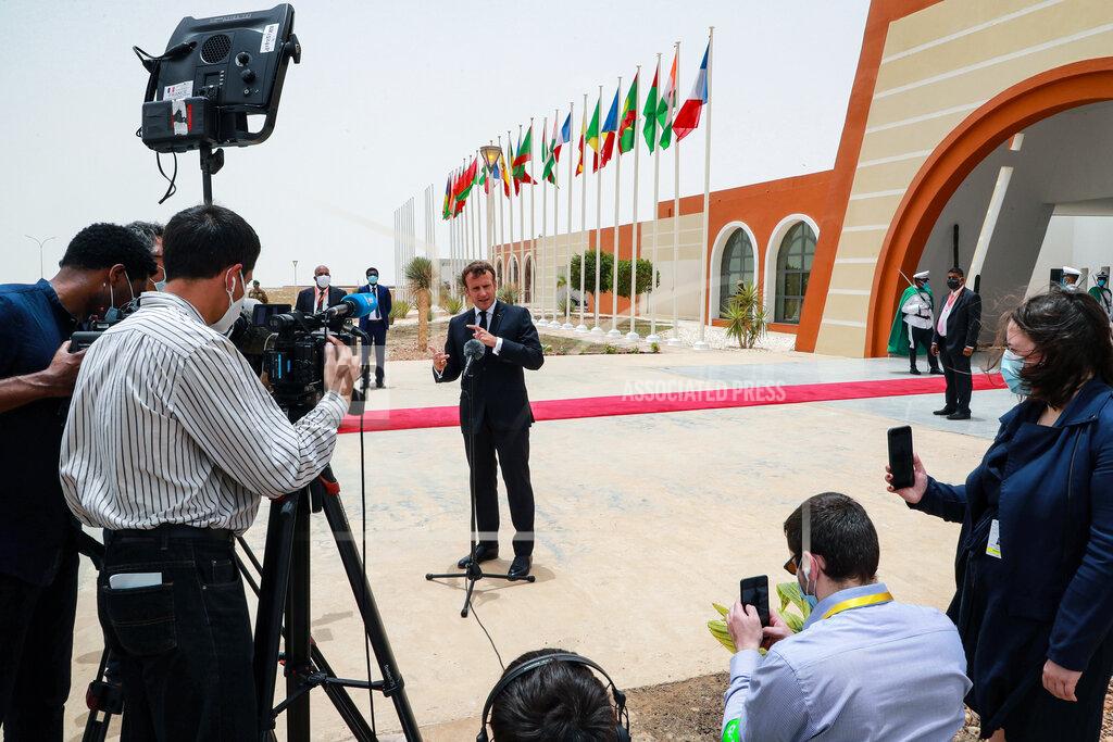 Ludovic Marin French President Emmanuel Macron speaks to the press upon arrival at Nouakchott Oumtounsy International Airport Tuesday June 30, 2020, in Nouakchott, to attend a G5 Sahel summit. Leaders from the five countries of West Africa's Sahel region, Burkina Faso, Chad, Mali, Mauritania and Niger, meet with French President Emmanuel Macron and Spanish Prime Minister Pedro Sanchez in Mauritania's capital Nouakchott on Tuesday to discuss military operations against Islamic extremists in the region, as jihadist attacks mount. The five African countries, known as the G5, have formed a joint military force that is working with France, which has thousands of troops to battle the extremists in the Sahel, the region south of the Sahara Desert. (Ludovic Marin, Pool via AP)