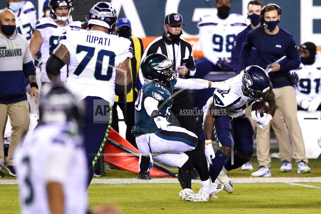 Derik Hamilton Philadelphia Eagles' Duke Riley (50) hangs onto Seattle Seahawks' Chris Carson (32) during the first half of an NFL football game, Monday, Nov. 30, 2020, in Philadelphia. (AP Photo/Derik Hamilton)