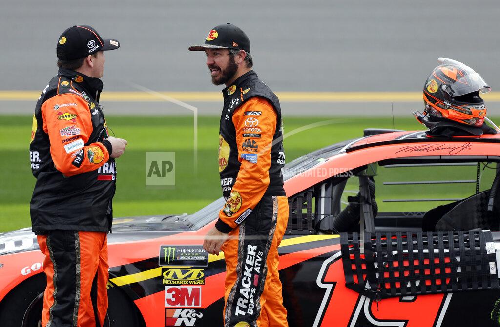 Terry Renna Martin Truex Jr., right, talks with a crew member during a rain delay in the NASCAR Clash auto race at Daytona International Speedway, Sunday, Feb. 10, 2019, in Daytona Beach, Fla. (AP Photo/Terry Renna)