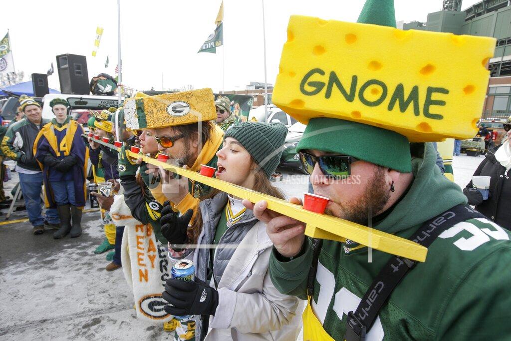 Mike Roemer Fans do a shot outside Lambeau Field before an NFL divisional playoff football game between the Green Bay Packers and the Seattle Seahawks Sunday, Jan. 12, 2020, in Green Bay, Wis. (AP Photo/Mike Roemer)