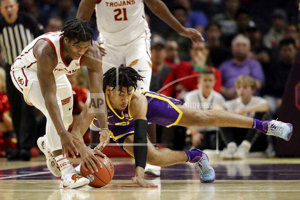 Marcio Jose Sanchez LSU forward Trendon Watford, right, dives for the ball next to Southern California guard Ethan Anderson during the first half of an NCAA college basketball game Saturday, Dec. 21, 2019, in Los Angeles. (AP Photo/Marcio Jose Sanchez)