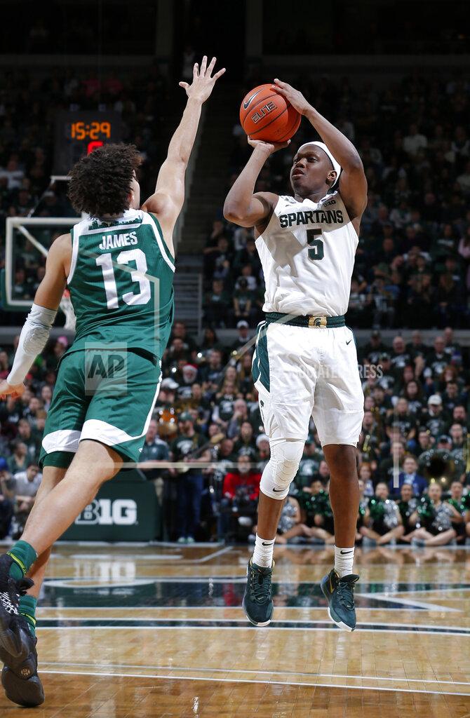 Al Goldis Michigan State's Cassius Winston, right, shoots against Eastern Michigan's Chris James (13) during the second half of an NCAA college basketball game, Saturday, Dec. 21, 2019, in East Lansing, Mich. (AP Photo/Al Goldis)