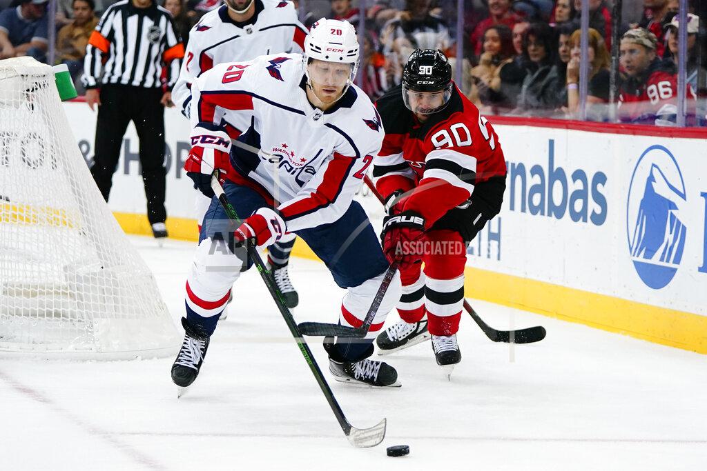 Frank Franklin Ii Washington Capitals' Lars Eller (20) and New Jersey Devils' Tomas Tatar (90) reach for the puck during the first period of an NHL hockey game Thursday, Oct. 21, 2021, in Newark, N.J. (AP Photo/Frank Franklin II)