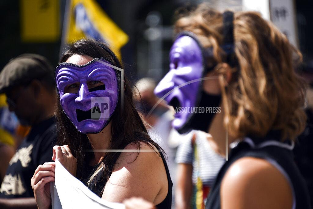 Alberto Pezzali Theatre workers protest outside the National Theatre, against the mass redundancies of low-paid art jobs due to the Coronavirus outbreak, in London, Saturday, Aug. 1, 2020. Prime Minister Boris Johnson put some planned measures to ease the U.K.'s lockdown on hold Friday, saying the number of new coronavirus cases in the country is on the rise for the first time since May. He called off plans to allow venues, including casinos, bowling alleys and skating rinks, to open from Saturday, Aug. 1. (AP Photo/Alberto Pezzali)