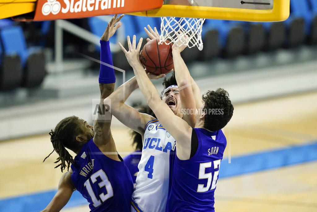 Ashley Landis Washington forward Hameir Wright (13) and center Riley Sorn (52) break up a shot by UCLA guard Jaime Jaquez Jr. (4) during the second half of an NCAA college basketball game Saturday, Jan. 16, 2021, in Los Angeles. (AP Photo/Ashley Landis)