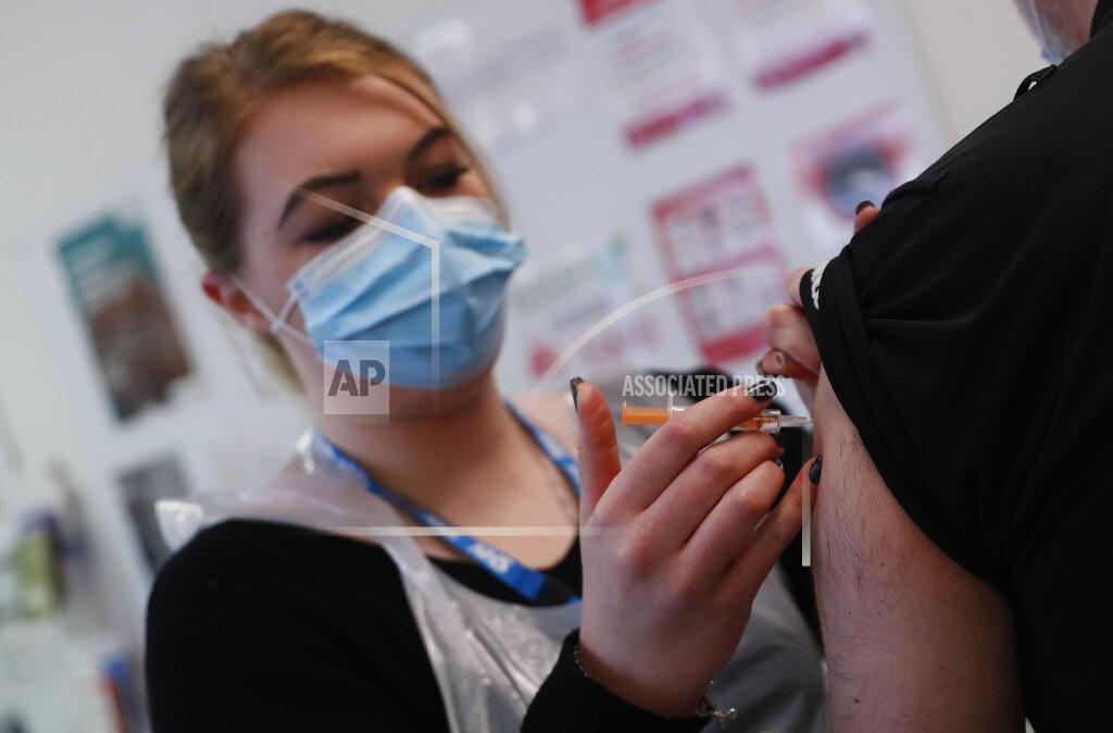 Alastair Grant Pharmacy Technician Katrina Bonwick administers a dose of the AstraZeneca COVID-19 vaccine at the Wheatfield surgery in Luton, England, Thursday, March 18, 2021. (AP Photo/Alastair Grant)