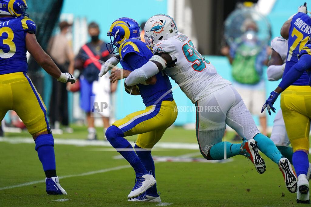 Wilfredo Lee FILE - In this Nov. 1, 2020, file photo, Miami Dolphins defensive end Shaq Lawson (90) sacks Los Angeles Rams quarterback Jared Goff (16), during the first half of an NFL football game, in Miami Gardens, Fla. Twelve months ago, they were 0-7 under first-year coach Brian Flores and allowing 34.0 points a game, and they went on to surrender the most points in franchise history. They've gone from worst to first in the NFL, and are now giving up 18.6 points per game. (AP Photo/Wilfredo Lee, File)