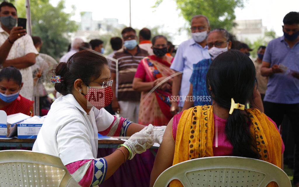 Ajit Solanki A health worker administers the COVISHIELD vaccine for COVID-19 at a residential area in Ahmedabad, India, Sunday, April 4, 2021. (AP Photo/Ajit Solanki)