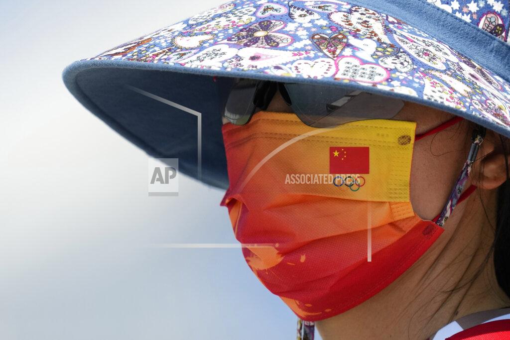 Lee Jin-Man Chinese national flag and the Olympic rings are seen on the mask of a member of Chinese rowing team during a rowing training session at the 2020 Summer Olympics, Thursday, July 22, 2021, in Tokyo, Japan. (AP Photo/Lee Jin-man)