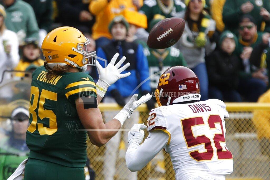 Matt Ludtke Green Bay Packers' Robert Tonyan catches a touchdown pass in front of Washington Football Team's Jamin Davis during the second half of an NFL football game Sunday, Oct. 24, 2021, in Green Bay, Wis. (AP Photo/Matt Ludtke)