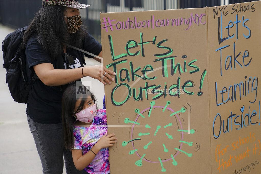 John Minchillo Teachers and students arrive to participate in an outdoor learning demonstration to display methods schools can use to continue on-site education during the coronavirus pandemic, Wednesday, Sept. 2, 2020, at P.S. 15 in the Brooklyn borough of New York. (AP Photo/John Minchillo)
