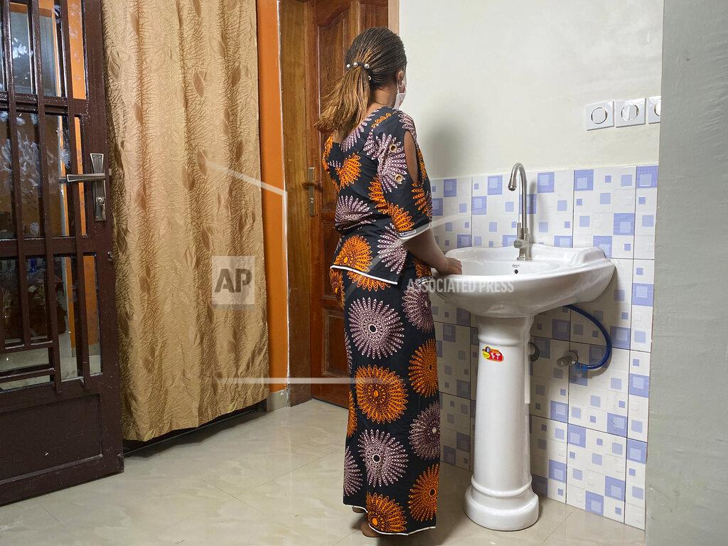 Kudra Maliro Anifa stands in her home in the eastern Congo town of Goma on Friday, March 5, 2021. In 2019, World Health Organization Dr. Boubacar Diallo, of Canada, met her when she was working in an Ebola treatment center in Beni, eastern Congo. She said Diallo told her: “How can a beautiful girl like you work here, testing people’s temperatures and washing their hands? That’s terrible.” She said he offered her another job at five times more than her current salary where “the conditions were very simple,” according to him. She rejected Diallo’s offer, saying that “if he hires me after sleeping with him...I would be a sex slave, not a WHO employee.” Diallo rejected those claims outright. (AP Photo/Kudra Maliro)