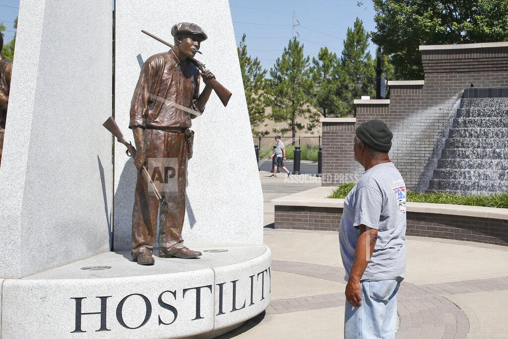 Sue Ogrocki Donald Shaw looks at a sculpture in the John Hope Franklin reconciliation park in Tulsa, Okla., Monday, June 15, 2020, a few hundred yards and on the other side of what's historically the city's white-black dividing line, where President Donald Trump will rally Saturday, June 20. (AP Photo/Sue Ogrocki)