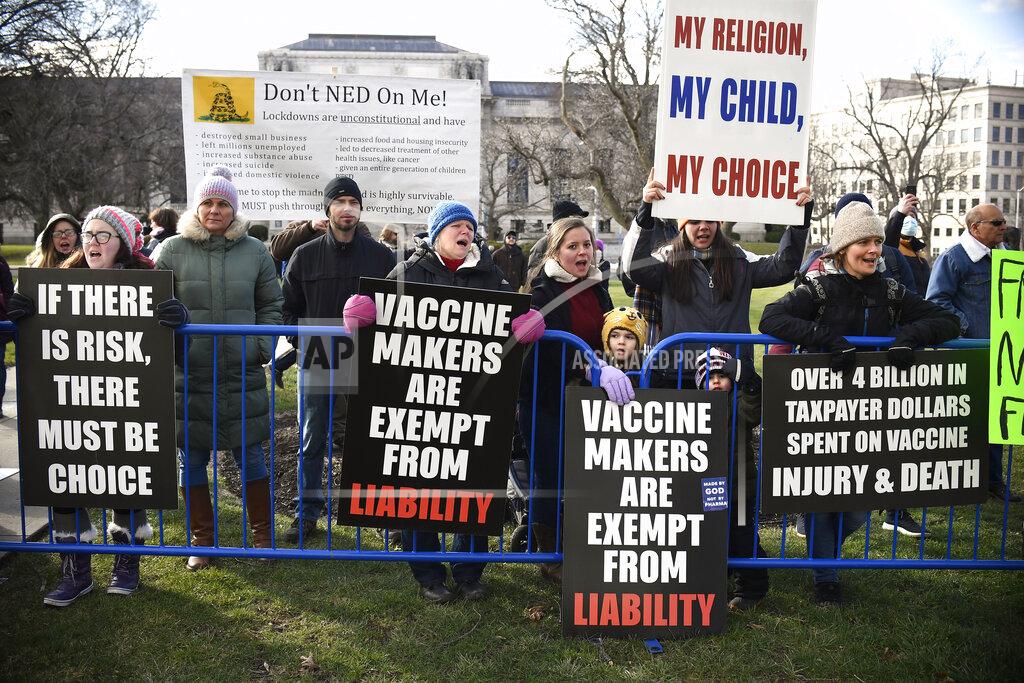 Jessica Hill Protesters gather outside on the State Capitol grounds, Wednesday, Jan. 6, 2021, in Hartford, Conn. Hundreds of protesters turned out for the swearing-in ceremonies. Many held up signs expressing support for President Donald Trump, or opposing any legislative effort to eliminate a religious exemption for vaccinations of schoolchildren. Others voiced support for the Black Lives Matter movement or pushed for racism to be declared a public health emergency. (AP Photo/Jessica Hill)