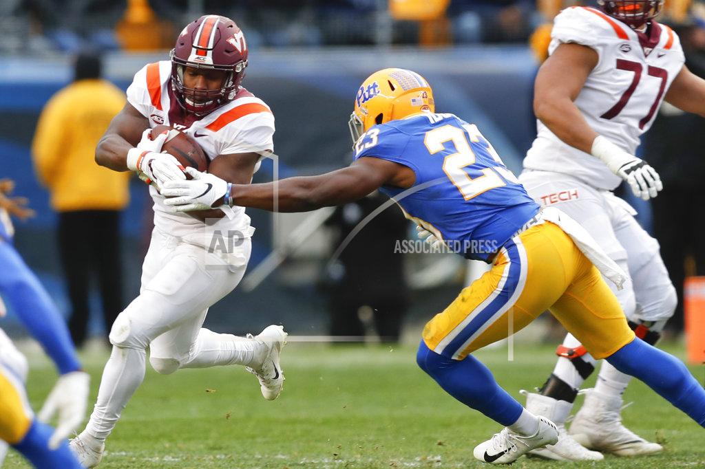 Keith Srakocic Virginia Tech running back Steven Peoples (32) runs away from Pittsburgh linebacker Oluwaseun Idowu (23) in the second quarter of an NCAA football game, Saturday, Nov. 10, 2018, in Pittsburgh. (AP Photo/Keith Srakocic)