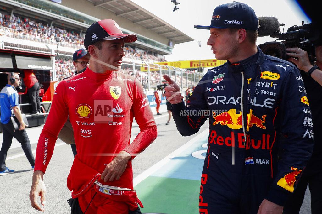 Joan Monfort Ferrari driver Charles Leclerc of Monaco, left, pole position, is flanked by second fastest time Red Bull driver Max Verstappen of the Netherlands after the qualifying session at the Barcelona Catalunya racetrack in Montmelo, Spain, Saturday, May 21, 2022. The Formula One race will be held on Sunday. (AP Photo/Joan Monfort)