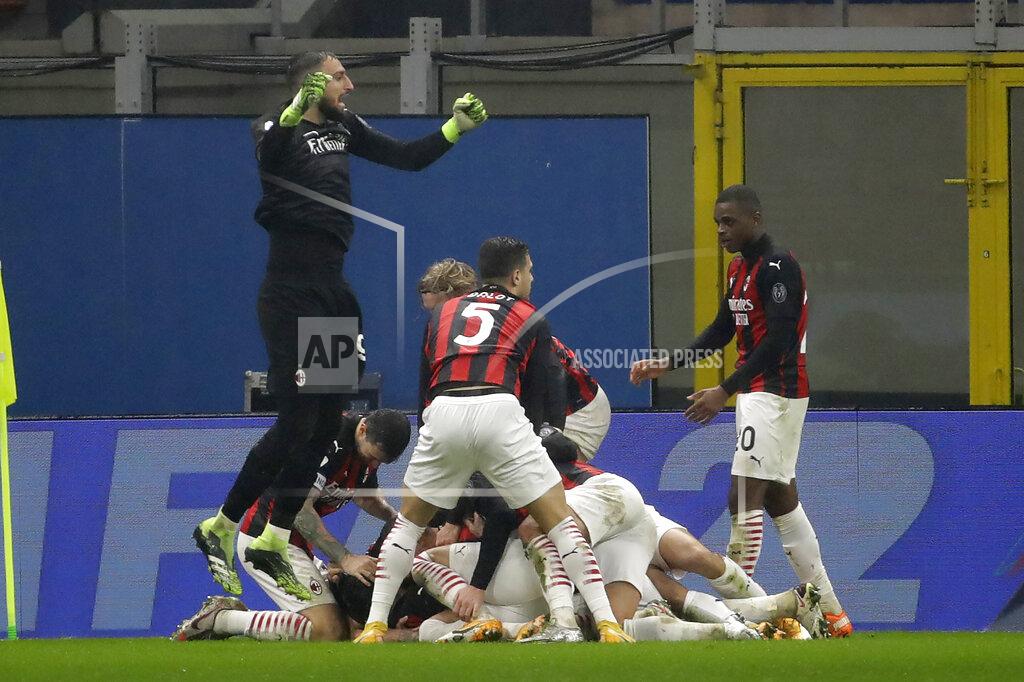 Luca Bruno AC Milan players celebrate the third goal against Lazio form their teammate Theo Hernandez during a Serie A soccer match between AC Milan and Lazio, at the San Siro stadium in Milan, Italy, Wednesday, Dec. 23, 2020. (AP Photo/Luca Bruno)