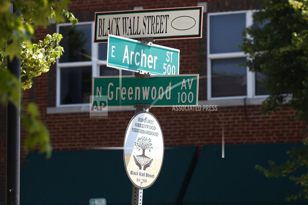 Sue Ogrocki A sign marks the intersection of Green and Archer, the former home of Black Wall Street, in Tulsa, Okla., Monday, June 15, 2020, on the other side of what's historically the city's white-black dividing line from where President Donald Trump will rally Saturday. (AP Photo/Sue Ogrocki)