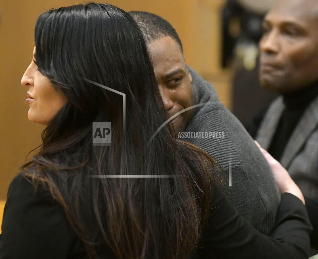Eli Lucero Torrey Green looks back at his family while being consoled by defense attorney Skye Lazaro, after a jury finds him guilty of eight charges including five counts of rape and a charge sexual battery in connection to reports from six women accusing him of sexual assault while he was a football player at Utah State University, Friday, Jan.18, 2019 in Brigham City, Utah. (Eli Lucero/Herald Journal via AP, Pool)