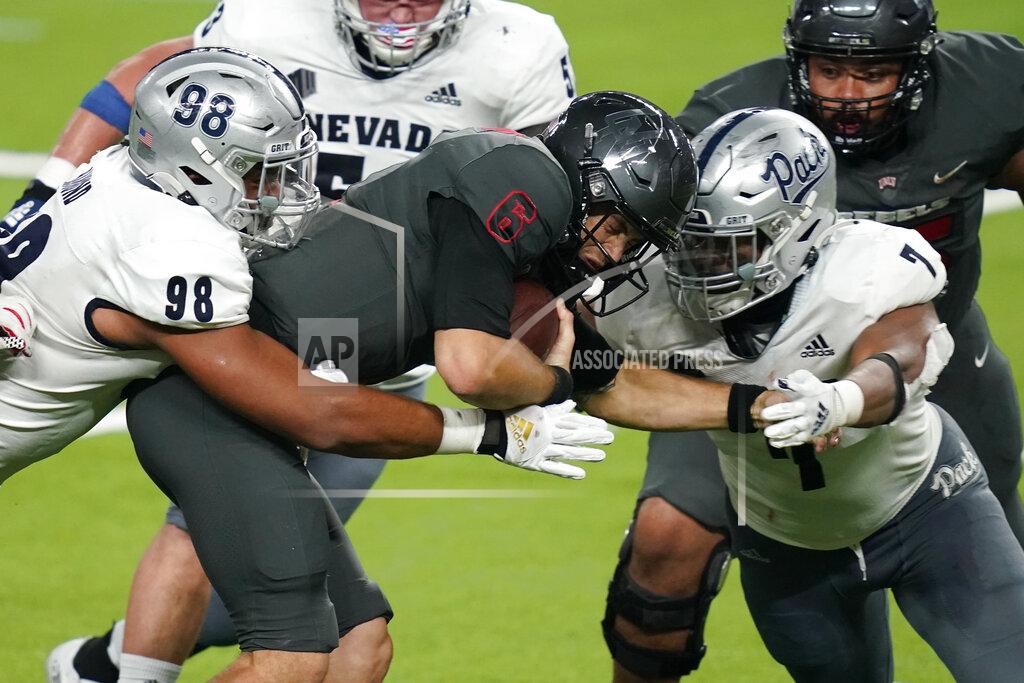John Locher Nevada defensive end Sam Hammond, left, and defensive end Kameron Toomer (7) sack UNLV quarterback Max Gilliam (6) during the second half of an NCAA college football game Saturday, Oct. 31, 2020, in Las Vegas. (AP Photo/John Locher)