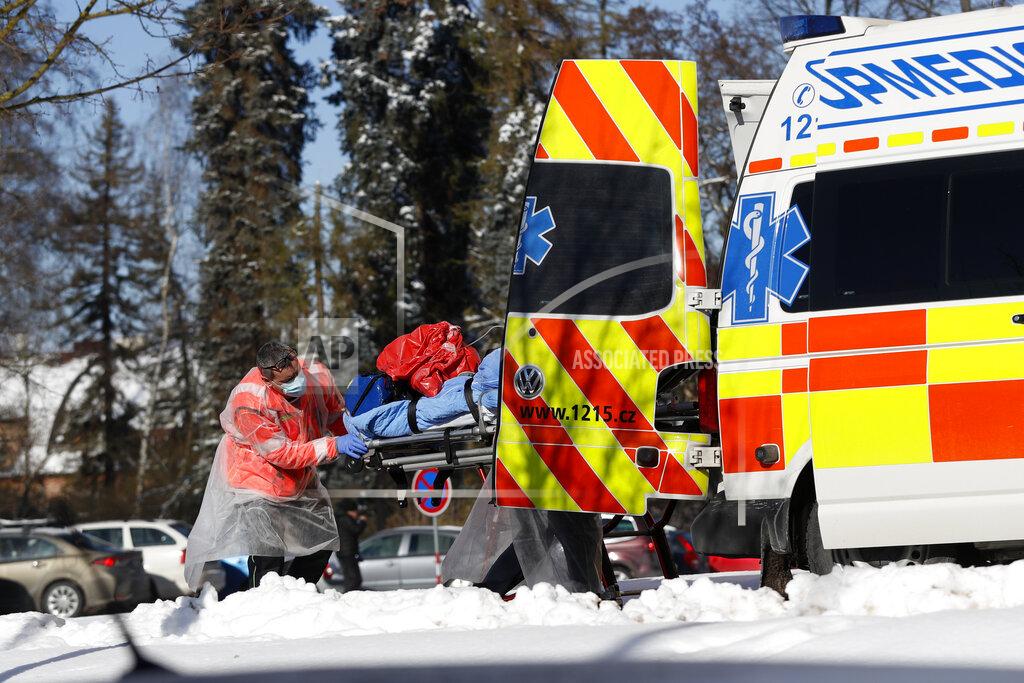 Petr David Josek Medical workers move a covid-19 patient at a hospital overrun by the covid pandemic in Cheb, Czech Republic, Friday, Feb. 12, 2021. The Czech government has imposed a complete lockdown of the three hardest-hit counties to help contain the spread of a highly contagious variant of the coronavirus. The meeasures will became effective Friday for the two counties in western Czech Republic on the German border Cheb and Sokolov and another county in the northern part of the country Trutnov located on the border with Poland. (AP Photo/Petr David Josek)