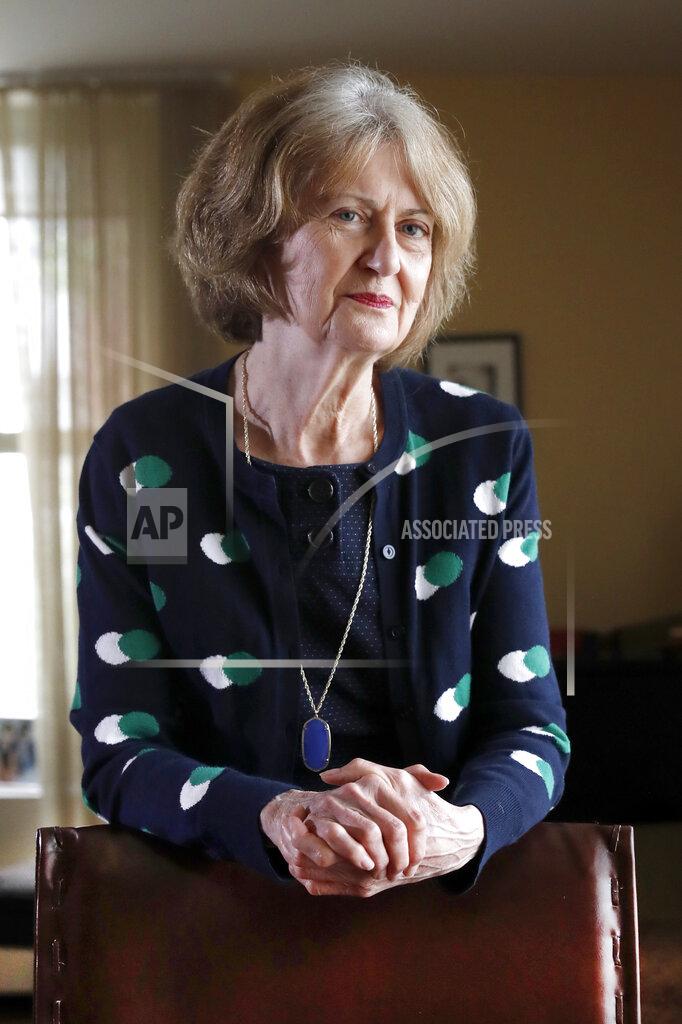 Senior U.S. District Judge Joan Lefkow, poses Monday, July 27, 2020, for a portrait in her Chicago home. In 2005, Lefkow returned from work to find her husband and mother shot dead in the basement of her Chicago home. Lefkow was forced to relive her family tragedy this month when a struggling lawyer armed with a gun and a grudge opened fire at the home of another female judge. (AP Photo/Charles Rex Arbogast)