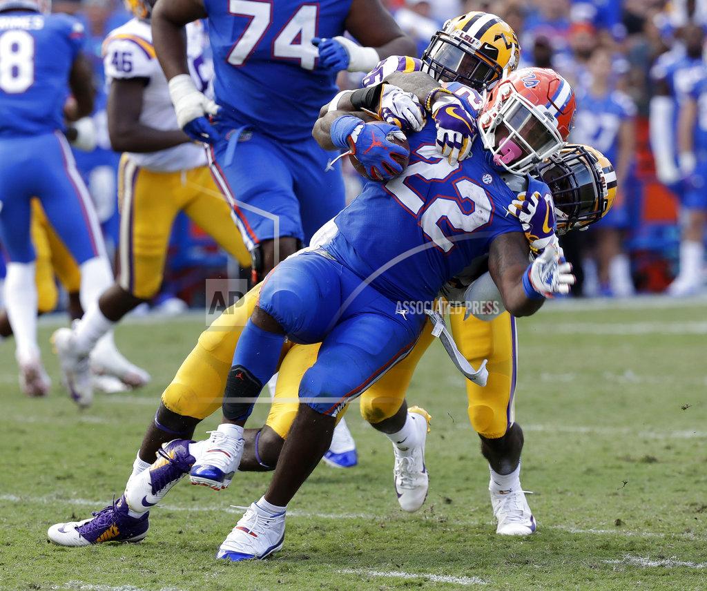 John Raoux Florida running back Lamical Perine (22) is stopped by the LSU defense after a short gain during the second half of an NCAA college football game Saturday, Oct. 6, 2018, in Gainesville, Fla. (AP Photo/John Raoux)