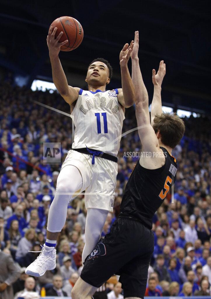 Charlie Riedel Kansas' Devon Dotson (11) shoots over Oklahoma State's Duncan Demuth (5) during the first half of an NCAA college basketball game Saturday, Feb. 9, 2019, in Lawrence, Kan. (AP Photo/Charlie Riedel)