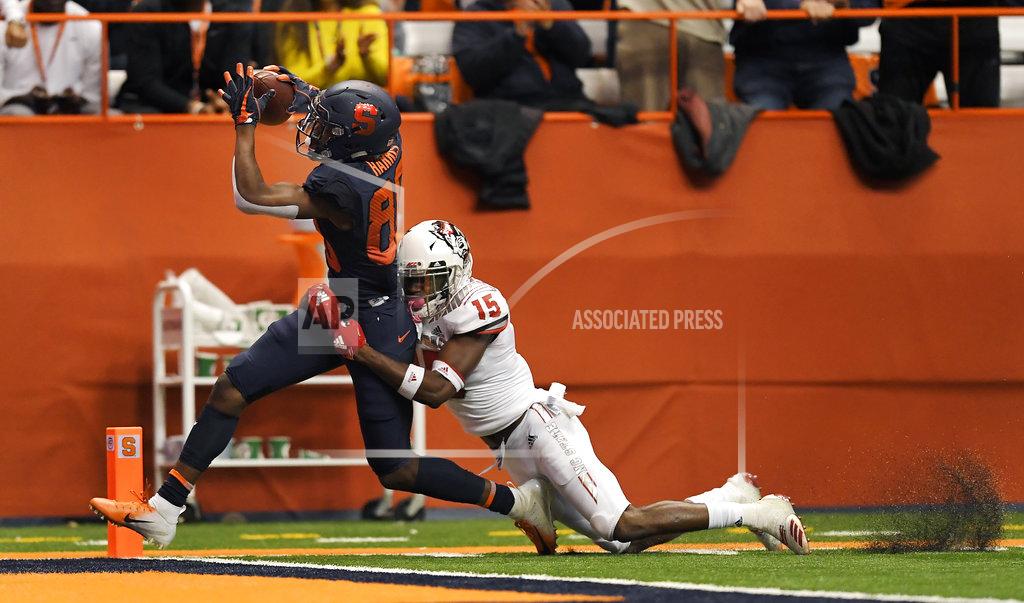 Adrian Kraus Syracuse wide receiver Taj Harris, left, drags North Carolina State cornerback Chris Ingram across the goal line for an Orange touchdown during the second half of an NCAA college football game in Syracuse, N.Y., Saturday, Oct. 27, 2018. (AP Photo/Adrian Kraus)