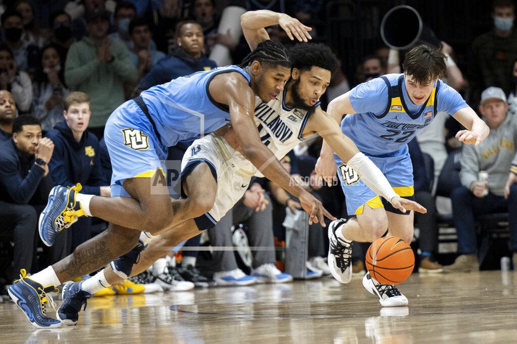 Laurence Kesterson Villanova guard Caleb Daniels (14) and Marquette forward Justin Lewis (10) and guard Tyler Kolek (22) chase a loose ball during the second half of an NCAA college basketball game, Wednesday, Jan. 19, 2022, in Villanova, Pa. (AP Photo/Laurence Kesterson)