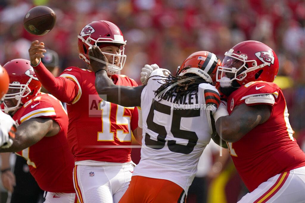 Kansas City Chiefs quarterback Patrick Mahomes (15) throws over Cleveland Browns defensive end Takkarist McKinley (55) during the first half of an NFL football game against the Cleveland Browns Sunday, Sept. 12, 2021, in Kansas City, Mo. (AP Photo/Charlie Riedel)
